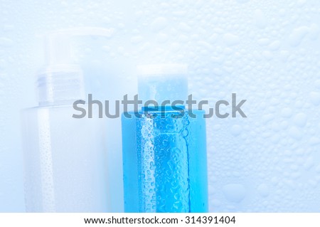 Daily cleansing cosmetics - face wash cleansing gel, smoothing toner with water drops on white background. Copy space.