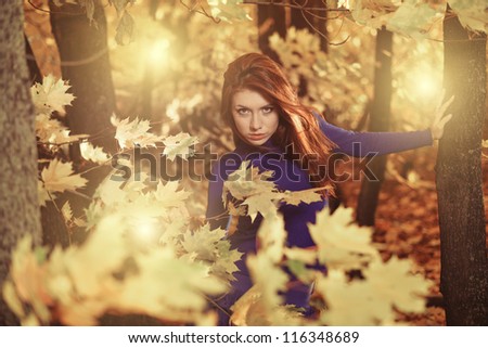 young woman at windy fall forest