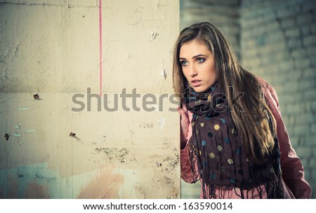 young woman portrait at grunge place