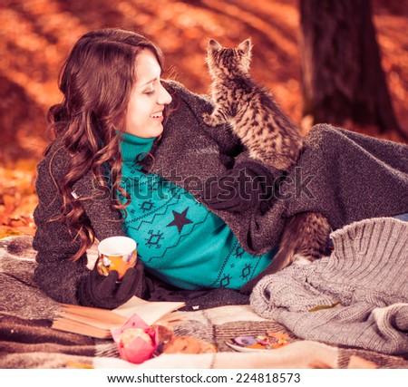 young lady and cats at fall forest