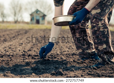 man in gloves working at spring season farm ground