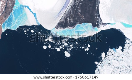 Glacier in Greenland, blocks of ice floating in the ocean, seasonal changes in glaciers. contains modified Copernicus Sentinel data