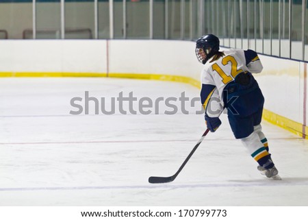 Female Ice hockey player during a game in an arena