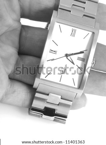 Close up of a hand holding a watch, in black and white.