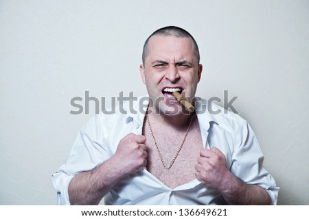 crazy evil man rips his shirt on his hairy chest on a white background