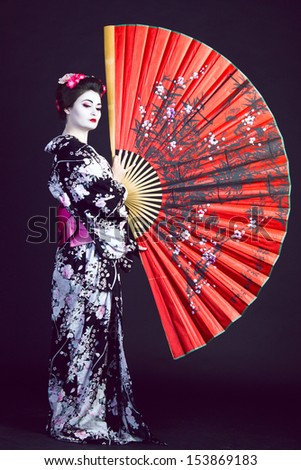 Japanese geisha with a red fan