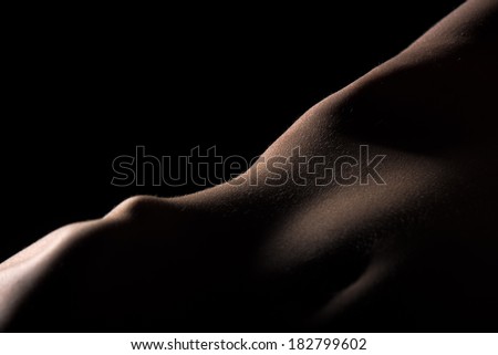 Skin on womans thigh hardly lighted like relief