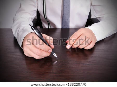 accountant working with pen in hand