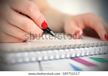 fountain pen writing or signing on a blank diary