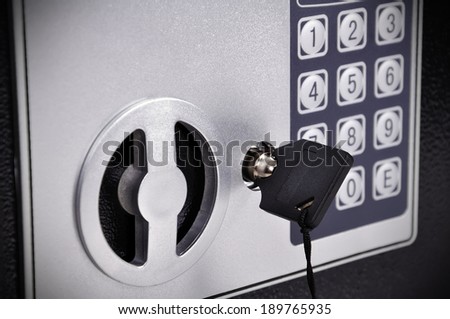 key is inserted in lock of safe