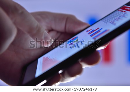 Accountant hand using phon and analyzes business report. Business and financial success concept. Close up ストックフォト © 