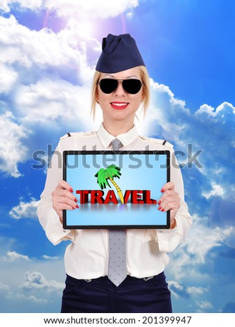 Flight attendant holding touch pad with travel symbol
