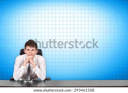 serious businessman sitting at conference table and blank screen