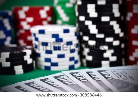 Poker Chips on a gaming table with dollars