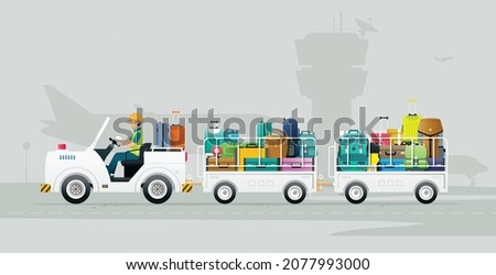 A worker drives a truck carrying luggage onto a plane at the airport.