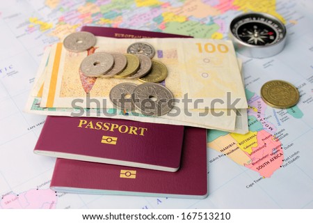 EU passports on Danish money, with a map and compass to symbolize travel.