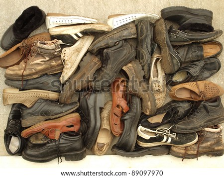 A large number of diverse old shoes