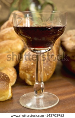 Still life assortment of bread with a glass of red wine. Selective focus on glass of red wine.