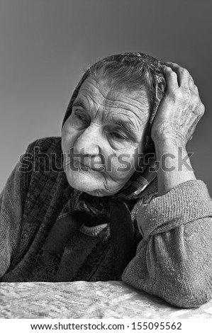 Portrait of sad lonely pensive old senior woman. Dreaming the past.