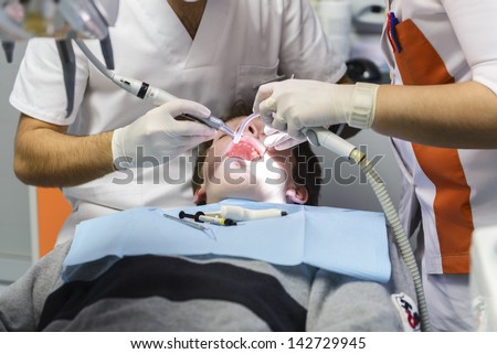 Dentist treats teeth to the patient in a private clinic