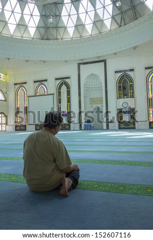 KUALA LUMPUR, MALAYSIA-AUG.18:An undentified Muslim man prays in a mosque (masjid) on August 18, 2013 in Kuala Lumpur, Malaysia.