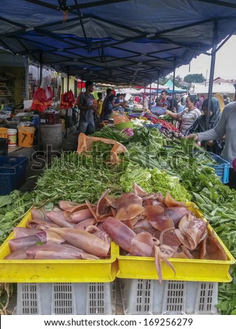 CHERAS, KUALA LUMPUR, MALAYSIA-DEC. 29: Unidentified people buy local produce at a local wet market in Cheras, Kuala Lumpur, Malaysia on December 29, 2013.