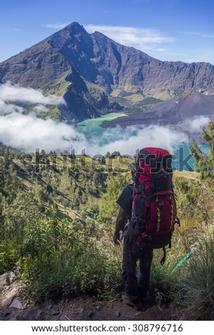 RINJANI MOUNTAIN, LOMBOK, INDONESIA-JUNE 11,2015: Mountain guide AB Pramono with trekking pole looks-on  on the way to Rinjani Mountain in Lombok, Indonesia.