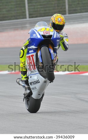 SEPANG, MALAYSIA - OCT 23 : Italian Valentino Rossi of Fiat Yamaha Team does a wheelie after a testing session during Shell Advance Malaysian Motorcycle Grand Prix held October 23, 2009 in Sepang, Malaysia.