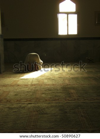 MECCA - JAN 3 : A Muslim pilgrim in \'ihram\' clothes prostrates during prayer in one of the mosques Jan 3, 2008 in Mecca. In Islam, an act of prostration is an act of submission to one God.