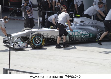 SEPANG, MALAYSIA - APRIL 8:Mechanics attend to Nico Rosberg of Mercedes GP Petronas F1 Team at PETRONAS Malaysian GP on April 8, 2011 in Sepang, Malaysia.The race will be held on April 10, 2011