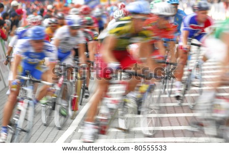 Motion blur of a group of cyclists in action during a cycling tour.