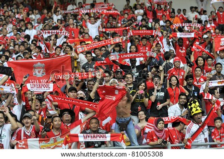 KUALA LUMPUR - JULY 14 : Liverpool football club fans cheer their players during warm up session on July 14, 2011 in Kuala Lumpur, Malaysia. Liverpool FC will meet Malaysian XI soccer team on July 16.