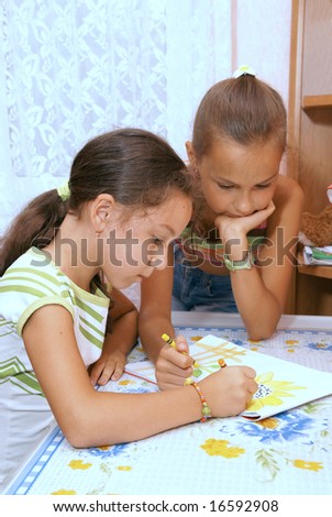School girls draw in album