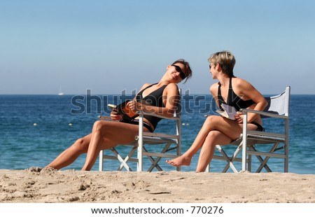 Two women reading on the beach
