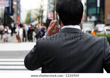 Businessman talking on the phone on the street
