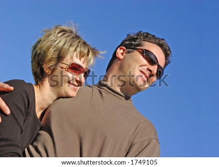 Happy couple against blue sky