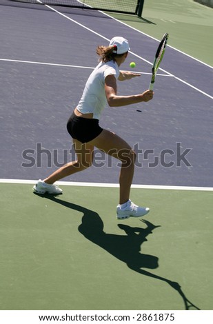 Woman playing tennis at the professional tournament