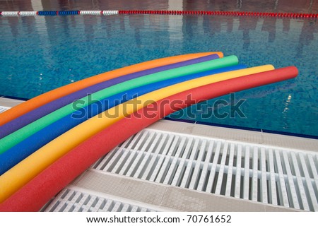 water aerobic equipment. colored aqua noodles in swimming pool