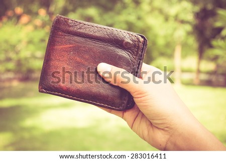 Hand and wallet with filter effect retro vintage style