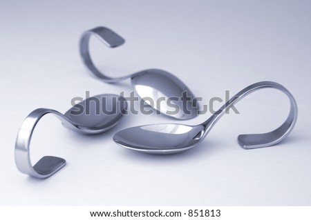 Three amuse bouche (bite-size appetizer) spoons, artistically arranged.