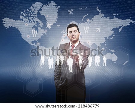 A businessman looks a hologram depicting a network of people with the background a virtual globe
