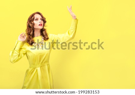 Fashion model lady with red hair   on yellow background