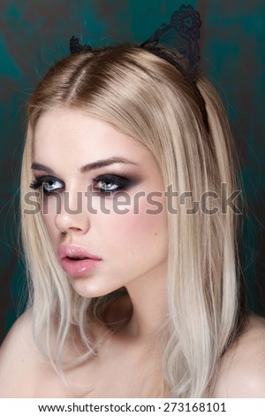 Portrait of beautiful stylish young woman with smokey eyes. Cat style. Big lips. Pure make up