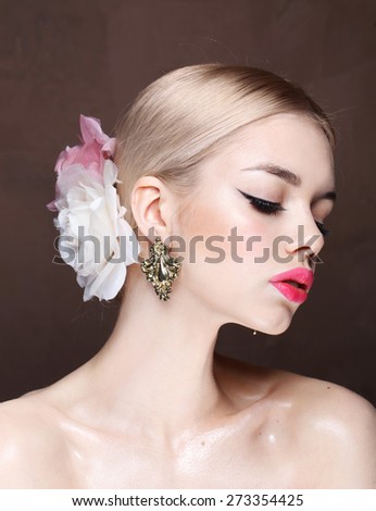 Fashion model with classic make up. Flowers. Spring look. Dolce style. Perfect skin, blonde hair. Big pink lips. Art background.