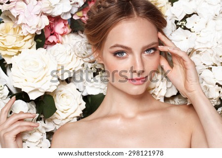 Portrait of a beautiful fashion bride, sweet and sensual.  Wedding make up and hair. Flowers background. Art modern style. Blue eyes
