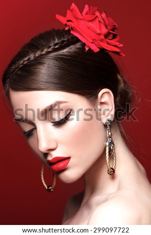 Beauty queen model with retro classic make up and red lips. Black arrows. Flowers in the hair. Natural shine skin.