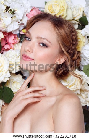 Portrait of a beautiful fashion bride, sweet and sensual. Wedding make up and hair. Flowers background. Art modern style. Blue eyes. Manicure.
