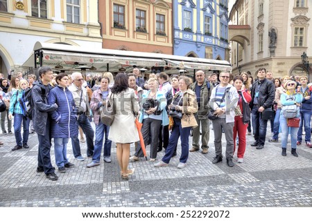 CZECH REPUBLIC, PRAGUE - April 28.2014: Guide tells about sights to the group of tourists