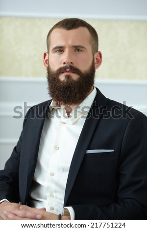 man in a suit with a long beard