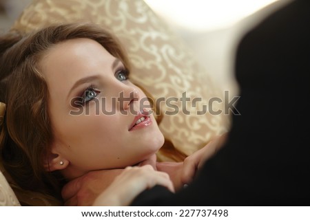 man strangling a woman on the bed